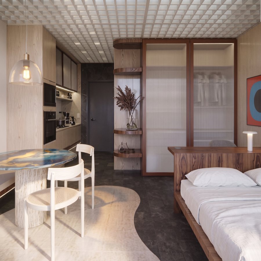 Studio integrado com cozinha, mesa redonda e cama com cabeceira de madeira